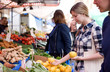 © michael spring - young woman shopping at the market