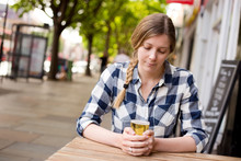 Young Woman Looking Thoughtful Holding Her Beer