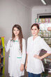 © DC Studio - Two happy pharmacist girls in drugstore
