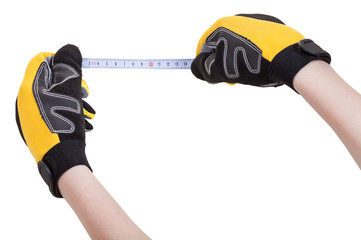 hands in protective glowes with measuring tape