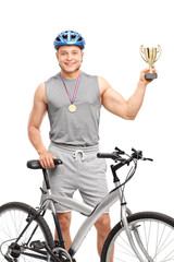 Wall Mural - Young male biker holding a trophy