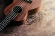 Close up of ukulele on old wood background with soft light