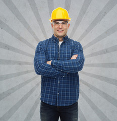 Canvas Print - smiling male builder or manual worker in helmet