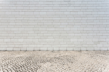 Wall Mural - white brick wall and empty sandstone road