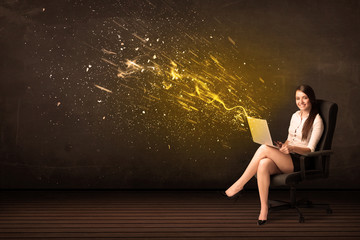 Canvas Print - Businesswoman with laptop and energy explosion on background