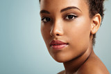 Fototapeta Londyn - pretty black woman's closeup portrait. blue background