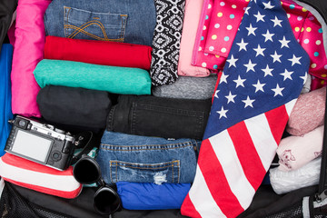 Open suitcase with clothing in the room