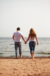 © Petr Malyshev - couple walking on a beach