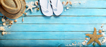 Seashells On Blue Wooden Plank With Straw Hat And Flip-flop 
