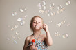 © vickyrandom - little cute girl blowing soap bubbles