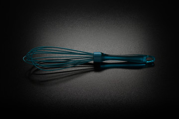egg beater on black table