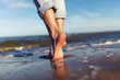 Leinwandbild Motiv feet of woman  in the sea waves