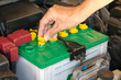 © Noey smiley - mechanic the battery of a car