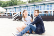 © ilya_oreshkov - Young couple relaxing sitting on the Baltic beach