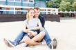 © ilya_oreshkov - Young couple relaxing sitting on the Baltic beach