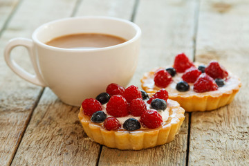 Wall Mural - Cup of coffee and sweet cakes with berries