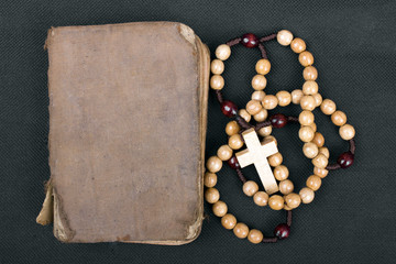 Wall Mural - rosary and prayer book on a dark background