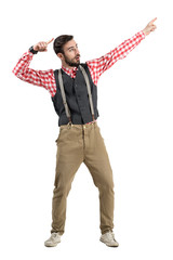 Happy hipster celebrating pointing up