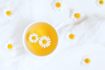 Wall Mural - Healthy natural chamomile herbal yellow tea in white cup with