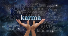 Cosmic Karma - Female Hands Cupped Upwards With The Word 'Karma' Floating Away Surrounded By A Relevant Word Cloud On A Deep Space Night Sky Dark Blue  Background 