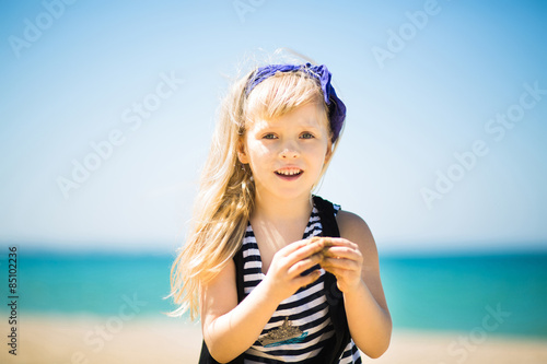 Pretty Little Girl With Blond Hair Walking On The Beach Buy This