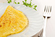 close up of omelette and fork on table