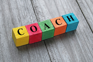 word coach on colorful wooden cubes
