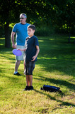 Fototapeta  - father and son playing disc golf
