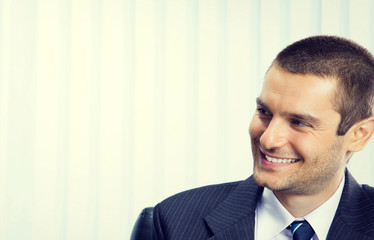 Happy smiling businessman, at office