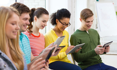 Wall Mural - smiling students with tablet pc at school