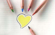Colored Pencils And A Drawing Of A Yellow  Heart 