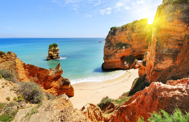 Rocky beach at sunset, Lagos, Portugal. Counter light. Travel and business background