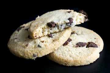 Wall Mural - Round chocolate chip shortbread biscuits. On black.