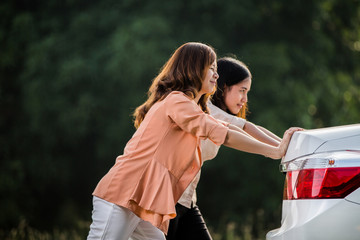 Two Asian women Are broken down car