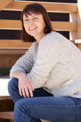 Wall Mural - Smiling older attractive woman sitting outside