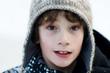 © sianc - close up of an eight year old boy wearing a wooly winter hat
