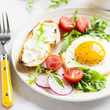 fried egg, vegetable salad and a grilled cheese sandwich on a light background