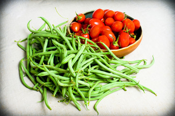 Raw green french beans and red tomatoes