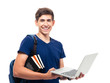 © Drobot Dean - Happy male student with backpack and books holding laptop isolated on a white background. Looking at camera