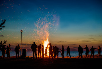 People resting near big bonfire outdoor