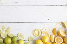 Lemons And Limes On White Wooden Background