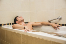 Handsome Young Man In Bathtub At Home Having Bath