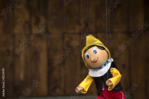 Old wooden pinocchio marionette toy .