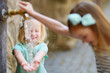 © MNStudio - Two girls playing with drinking water fountain
