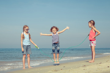 two sisters and brother playing on the beach