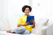 © Syda Productions - happy african american woman with tablet pc