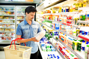 man in a supermarket buying sliced bacon