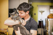 © theartofphoto - Handsome Young Man Hugging his Gray Cat Pet