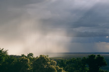 An Intense Rain Storm Approaches, Its Rain Clouds Intercepted By The Sunrays Of The Sunset, Making For A Fantastic View. Registered From A Mountain Top, In The Midst Of The Jungle, In Cambodia.