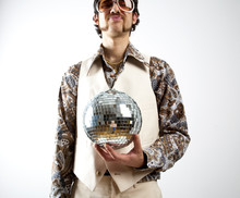 Portrait Of A Retro Man In A 1970s Leisure Suit And Sunglasses Holding A Disco Ball - Mirror Ball